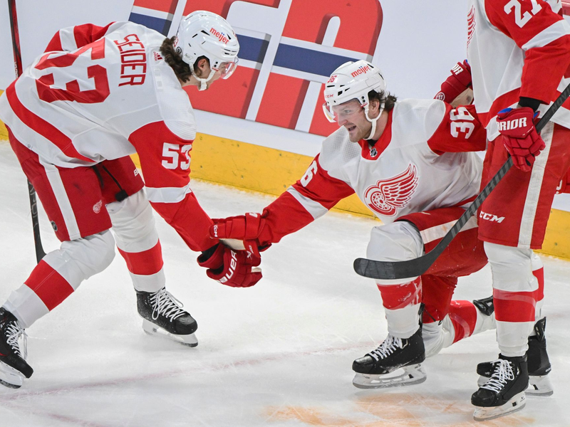 Christian Fischer (36) von den Detroit Red Wings feiert mit seinem Teamkollegen Moritz Seider (53). - Foto: Graham Hughes/The Canadian Press/AP