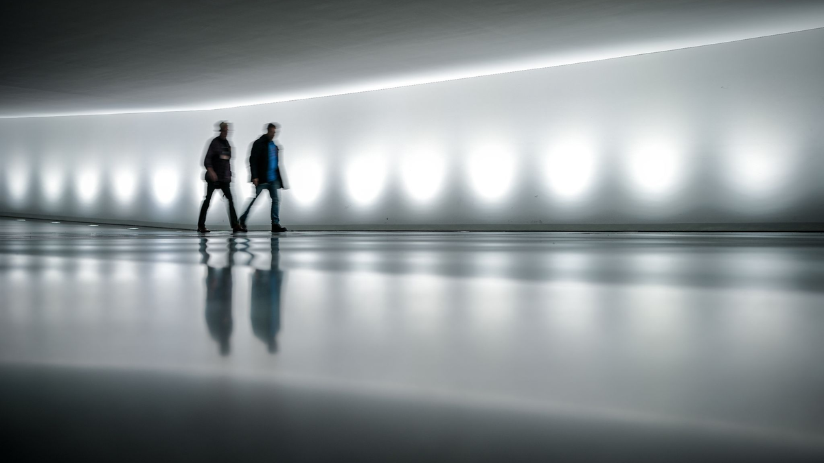Mitarbeiter gehen durch den Verbindungstunnel vom Reichstagsgebäude mit dem Bundestag zum Paul-Löbe-Haus. Seit Tagen ringen die Spitzen der Regierungsparteien hinter verschlossenen Türen um Wege aus dem Milliardenloch im Haushalt. - Foto: Kay Nietfeld/dpa
