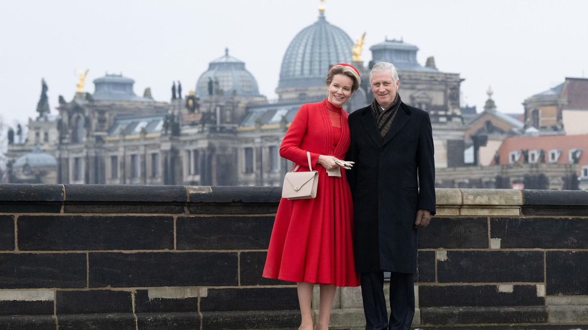 Königin Mathilde und König Philippe von Belgien stehen auf der Augustusbrücke vor der Kuppel der Kunstakedemie in Dresden. - Foto: Sebastian Kahnert/dpa