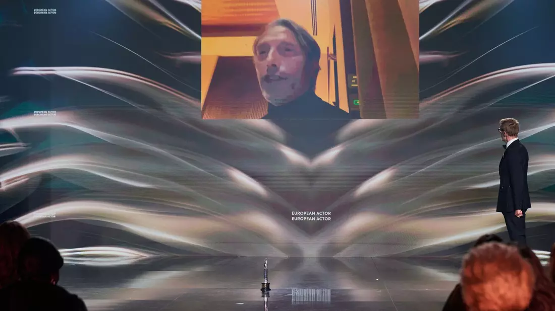 Mads Mikkelsen bedankt sich per Video für seinen Preis. - Bild: Annette Riedl/dpa