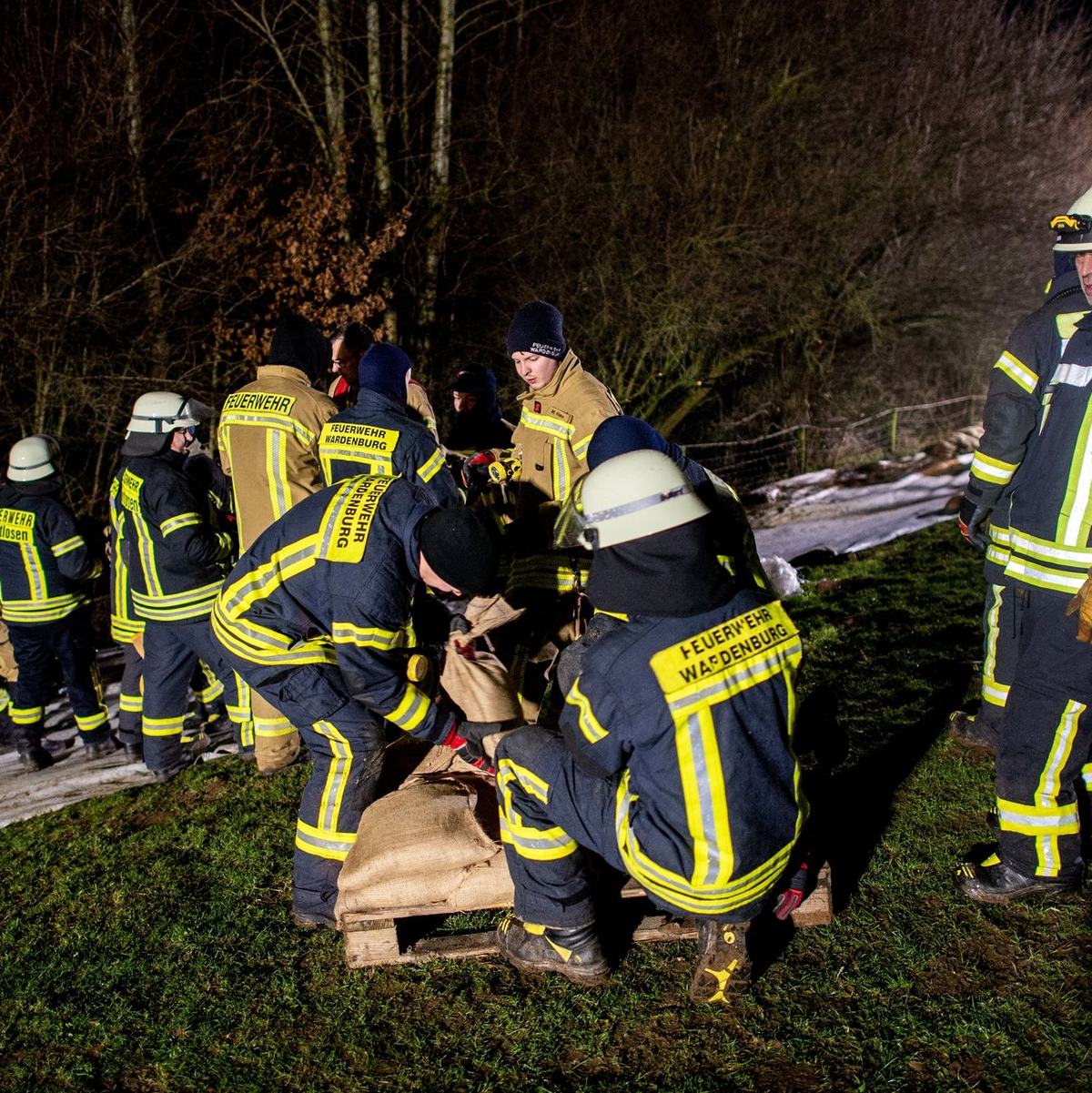 Einsatzkräfte der Feuerwehr sichern den aufgeweichten Deich der Hunte nahe der Ortschaft Astrup mit Vlies und Sandsäcken. - Foto: Hauke-Christian Dittrich/dpa