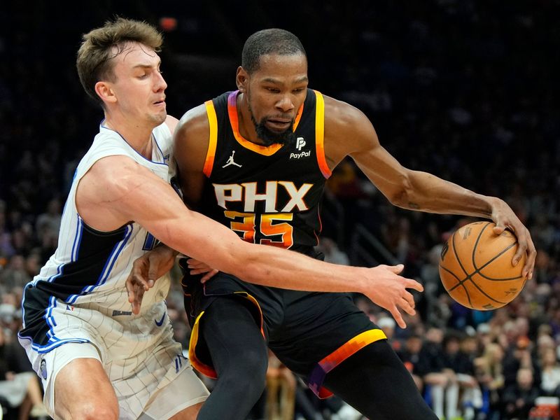 Franz Wagner (l) verteidigt gegen Suns-Starspieler Kevin Durant. - Foto: Rick Scuteri/AP/dpa
