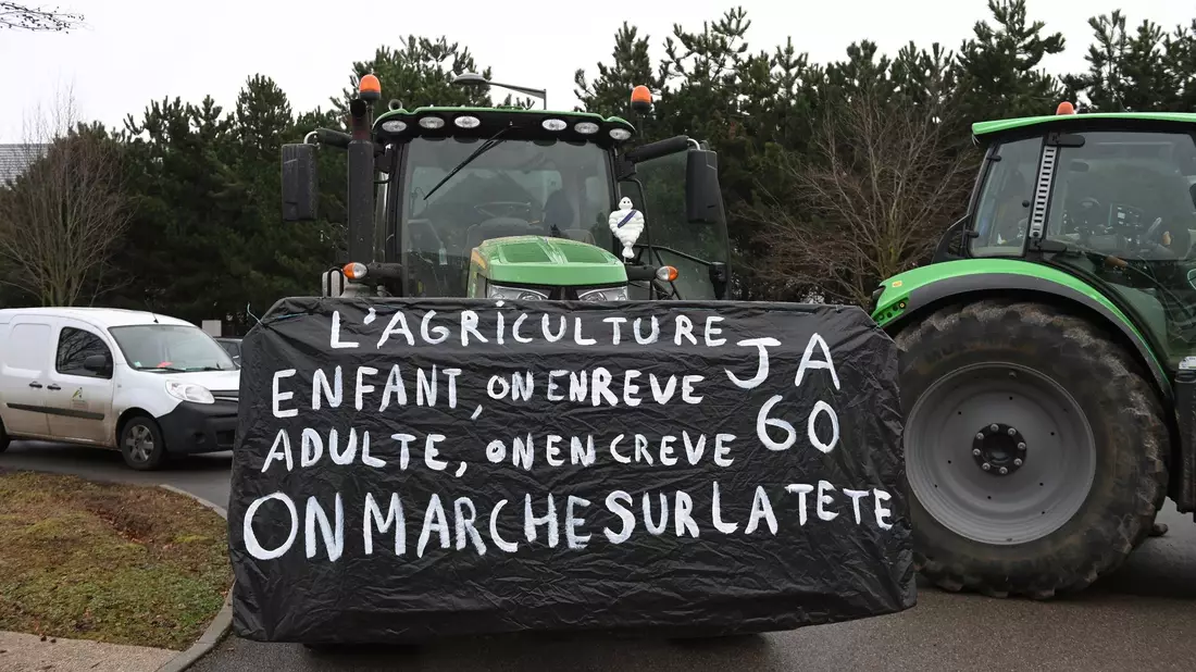 Landwirte vor einer Demonstration in der Nähe von Beauvais in Nordfrankreich. Auf dem Banner steht: Landwirtschaft, ein Kindheitstraum, der uns als Erwachsene umbringt. Die Welt ist aus den Fugen geraten. - Bild: Matthieu Mirville/AP/dpa