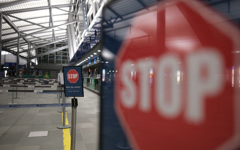 Stop-Schilder in einer leeren Flughafen-Halle. - Foto: Sebastian Willnow/dpa