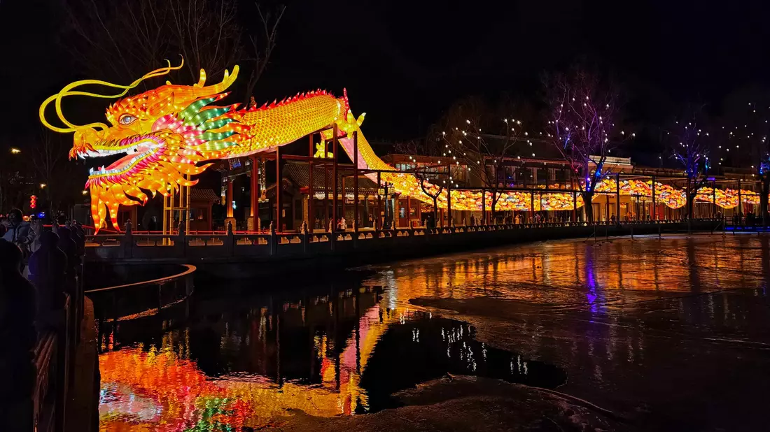 Eine drachenförmige Lichtinstallation am Mondneujahrsabend im Shichahai-Gebiet in Peking. - Bild: Li Muzi/XinHua/dpa