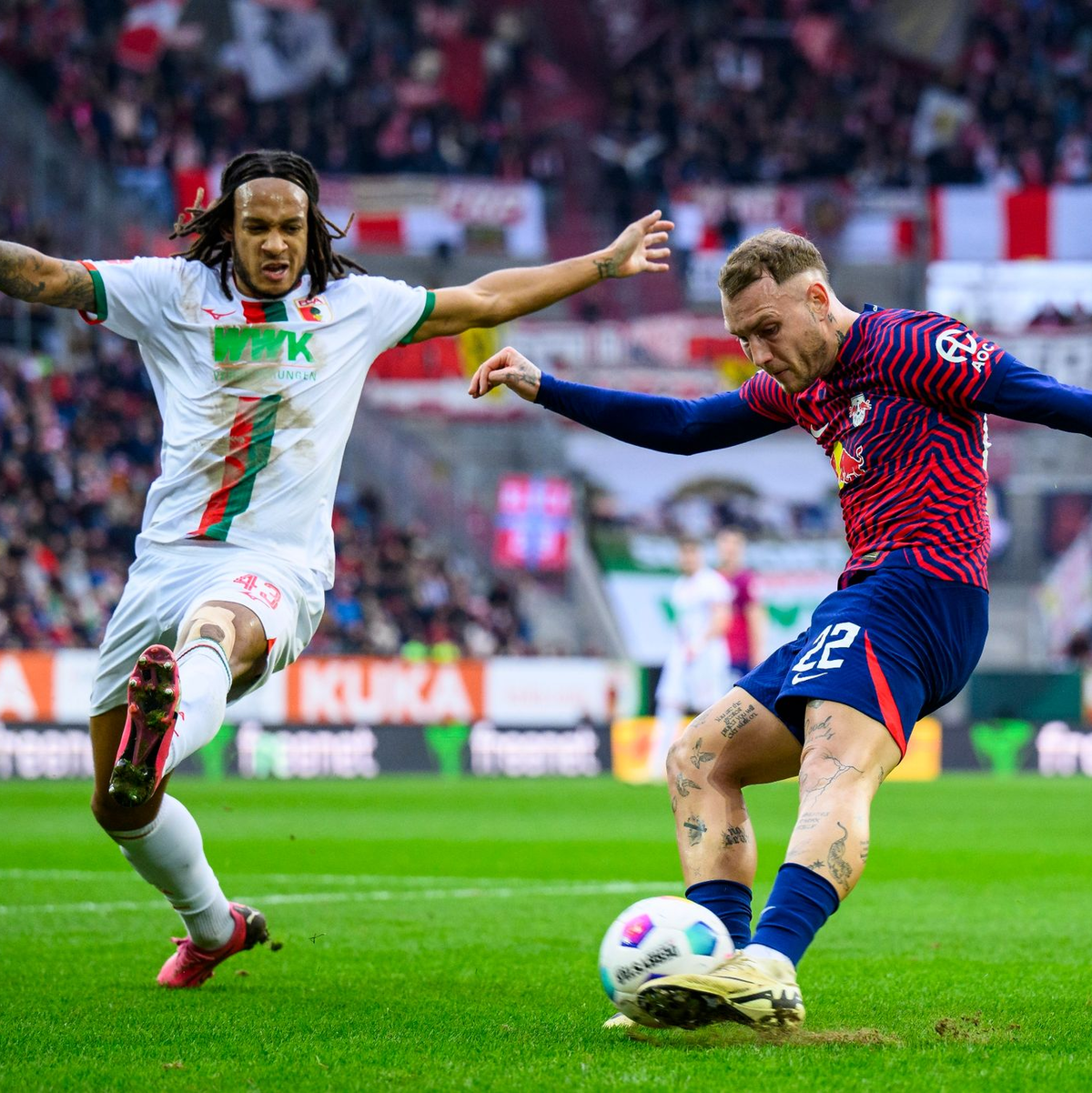 RB-Profi David Raum (r) flankt gegen den Augsburger Kevin Mbabu. - Foto: Tom Weller/dpa