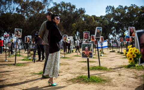 Überlebende und Angehörige gedenken der Opfer auf dem Gelände des Musikfestivals Supernova. - Foto: Ilia Yefimovich/dpa