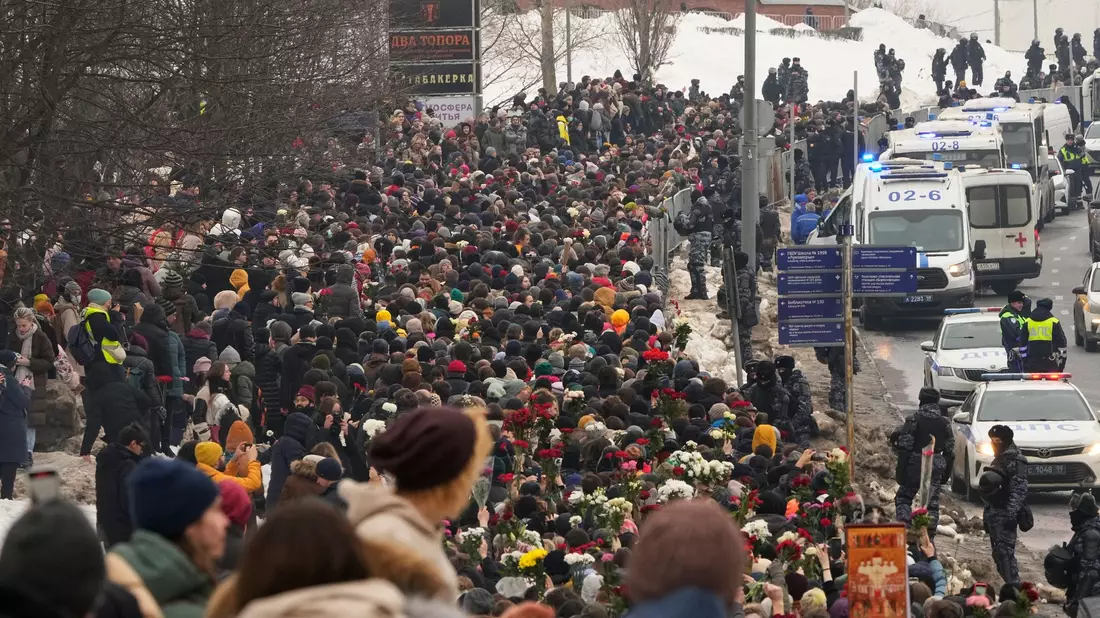 Polizisten beobachten, wie Menschen zur Beerdigungszeremonie des russischen Oppositionellen Nawalny gehen. - Bild: Uncredited/AP/dpa