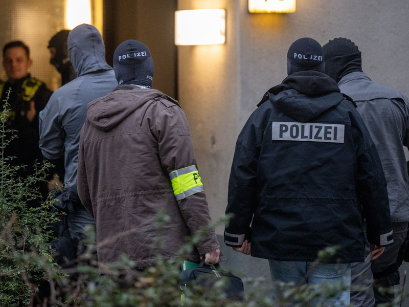 Maskierte Polizisten dursuchen das Wohnhaus der früheren RAF-Terroristin Daniela Klette in Berlin-Kreuzberg. - Foto: Monika Skolimowska/dpa