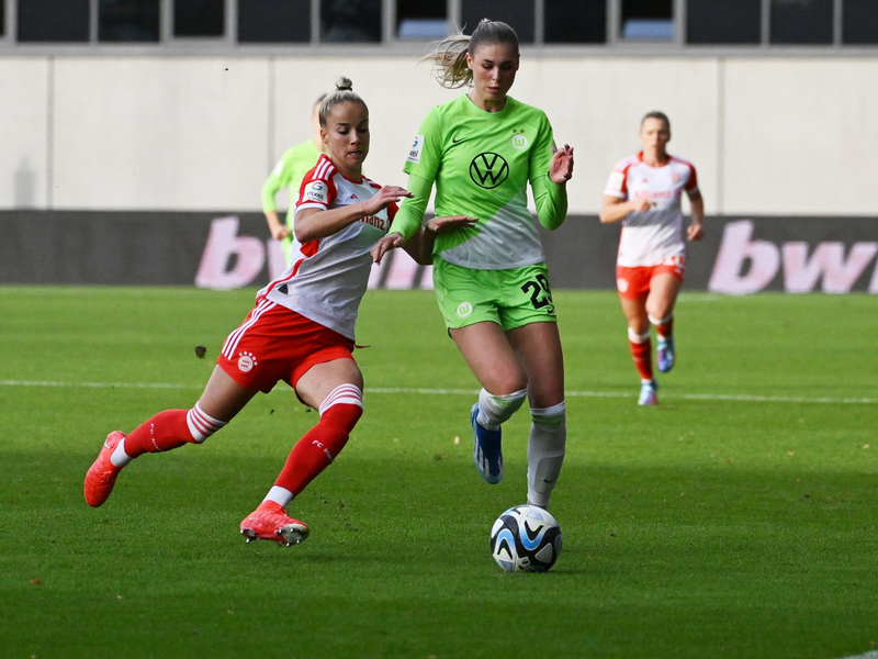 Bayern Münchens Giulia Gwinn (l) im Zweikampf mit Jule Brand vom VfL Wolfsburg. - Foto: Angelika Warmuth/dpa