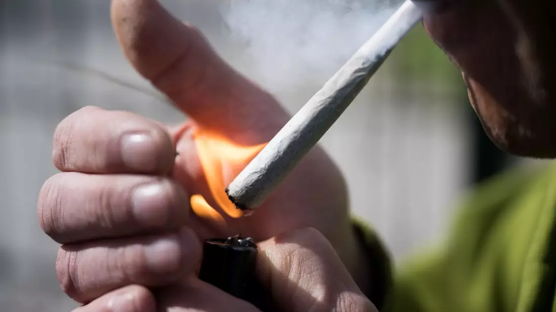 Ein Mann raucht einen Joint. Der Bundesrat hatte am 22. März 2024 den Weg zur Teil-Legalisierung von Cannabis zum 1. April freigemacht. - Bild: Sebastian Gollnow/dpa