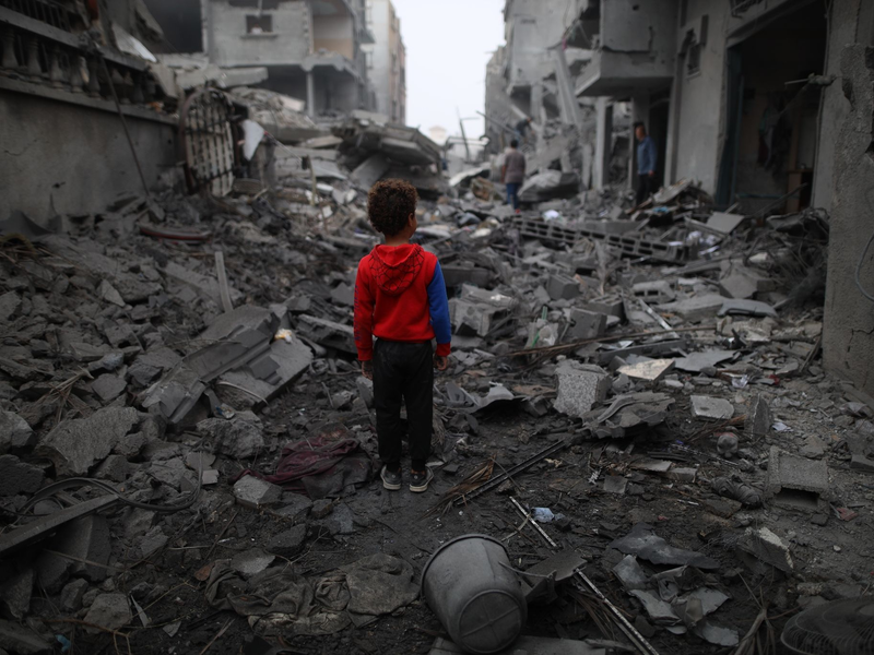 Ein Junge steht vor den Trümmern nach einem Luftangriff im Flüchtlingslager Maghazi im Zentrum des Gazastreifens. Schon sechs Monate lang tobt der Gaza-Krieg. - Foto: Uncredited/XinHua/dpa