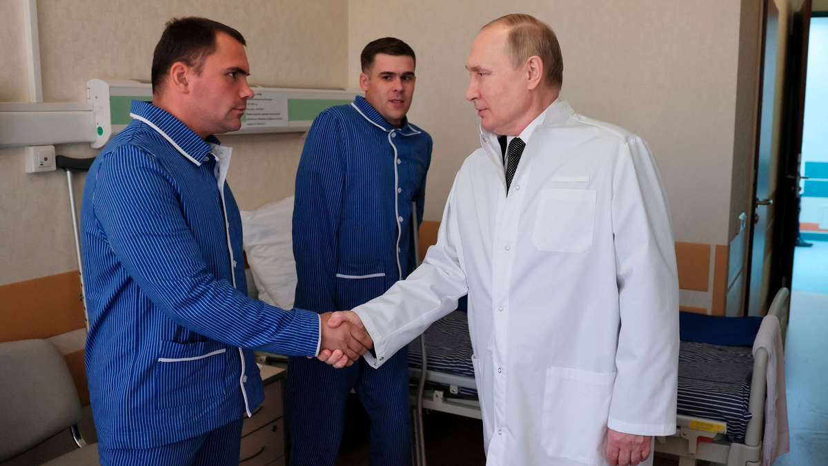 Russlands Präsident Wladimir Putin (r.) während eines Besuchs von verletzten Gefreiten im zentralen Militärkrankenhaus in Moskau. - Foto: Mikhail Metzel/Sputnik Kremlin/AP/dpa