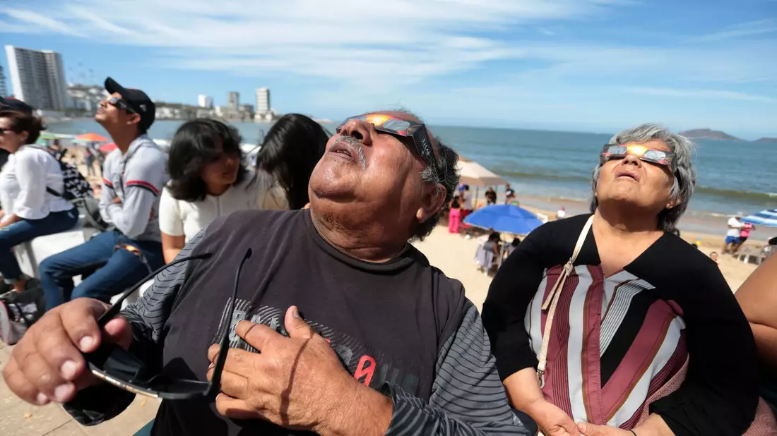 Menschen haben sich im Hafen von Mazatlán in Mexiko versammelt, um die totale Sonnenfinsternis beobachten. - Bild: Eduardo Resendiz/dpa