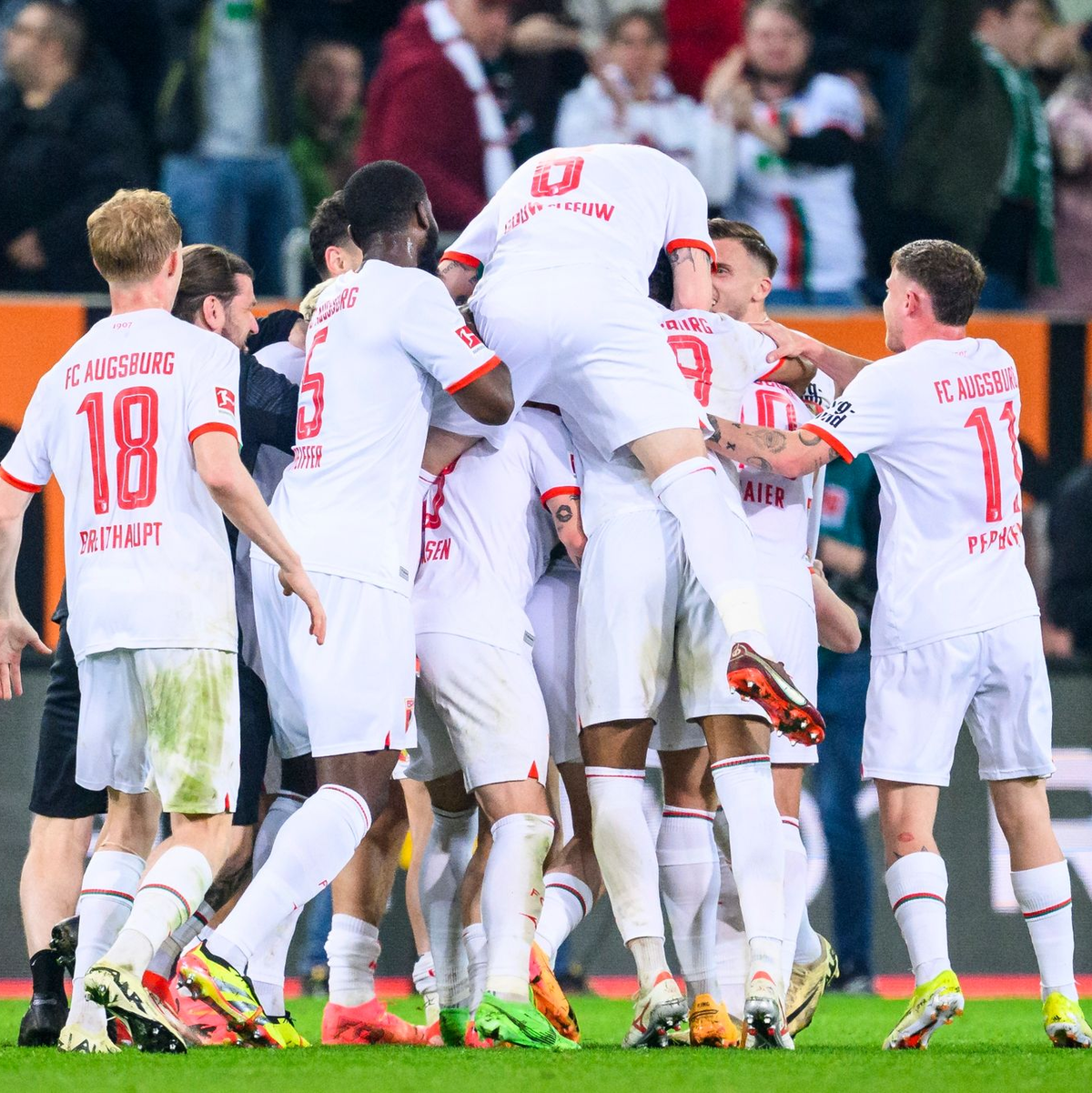 Die Augsburger Spieler feiern den Sieg gegen den 1. FC Union Berlin. - Foto: Tom Weller/dpa
