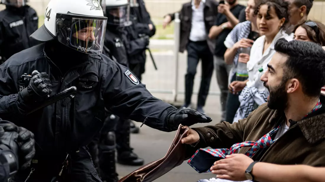 Ein Polizist und ein Demonstrant stoßen bei der Demonstration in Berlin-Mitte aufeinander. Die Polizei war mit rund 900 Kräften in der Stadt im Einsatz. - Bild: Fabian Sommer/dpa