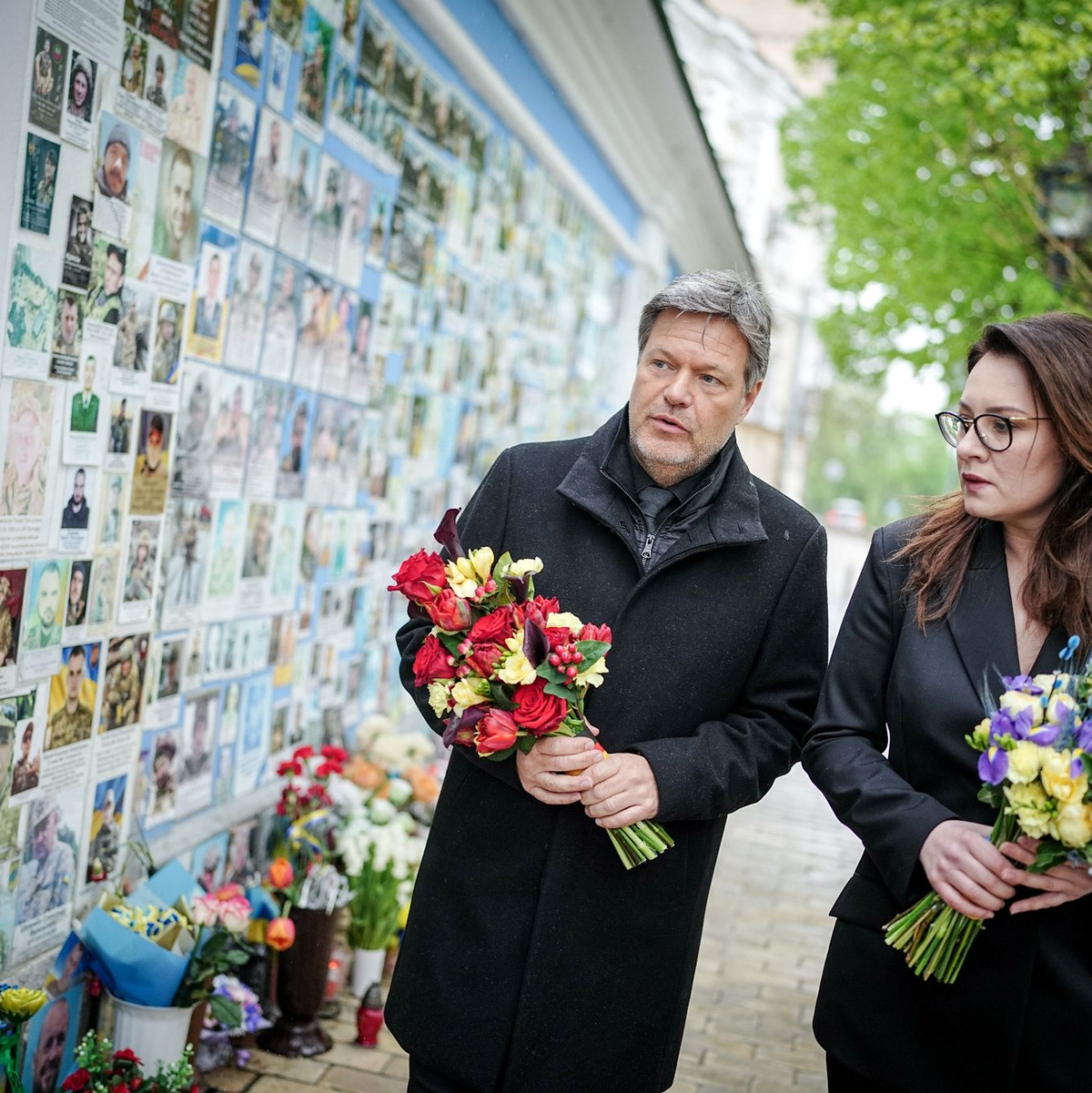 Vizekanzler Robert Habeck legt zusammen mit Julija Swyrydenko, der Ersten Stellvertretenden Premierministerin und Ministerin für Wirtschaft der Ukraine, an der Gedenkmauer für die im Krieg gefallenen Soldaten Blumen nieder. - Foto: Kay Nietfeld/dpa