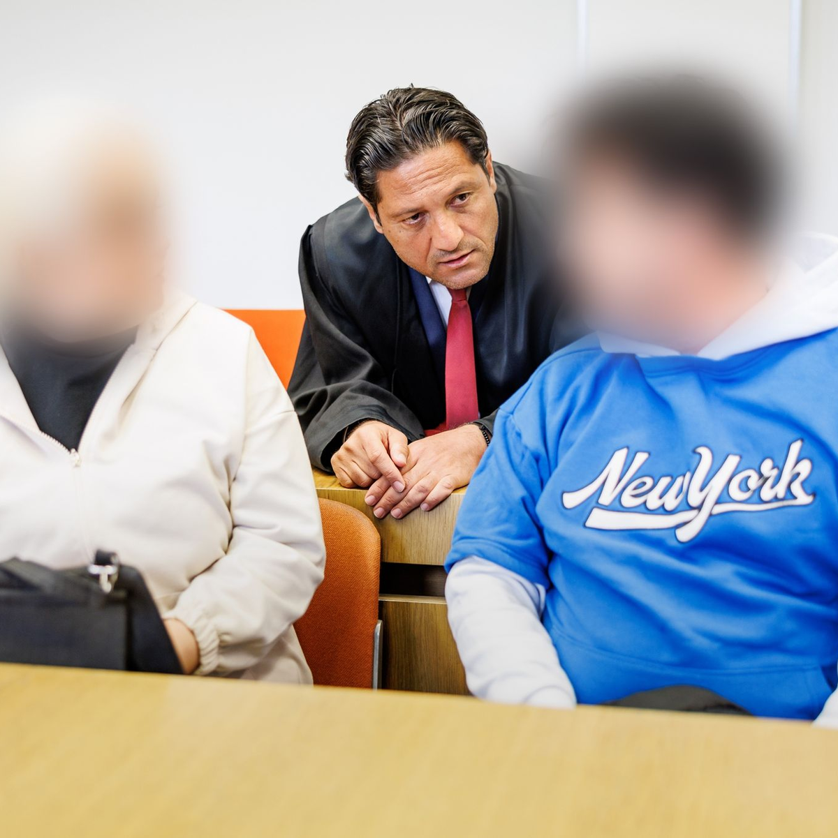 Die Angeklagten besprechen sich mit ihrem Strafverteidiger. - Foto: Matthias Balk/dpa