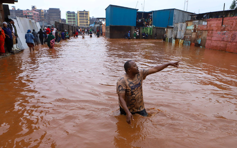 Ein Mann watet in Nairobi durch das Hochwasser. - Foto: Joy Nabukewa/XinHua/dpa