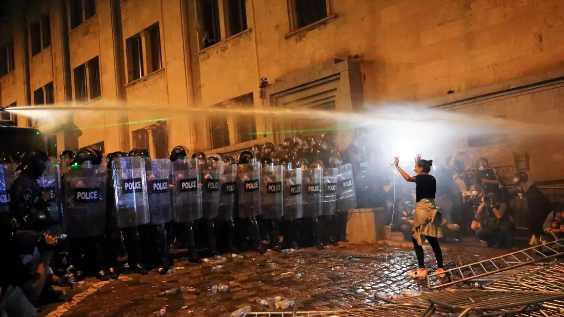 Eine Demonstrantin steht in Tiflis Bereitschaftspolizisten gegenüber. - Bild: Zurab Tsertsvadze/AP/dpa