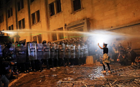 Eine Demonstrantin steht in Tiflis Bereitschaftspolizisten gegenüber. - Foto: Zurab Tsertsvadze/AP/dpa