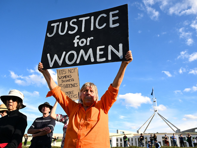 In Canberra fordert eine Frau Justice for Women (Gerechtigkeit für Frauen). - Foto: Lukas Coch/AAP/dpa