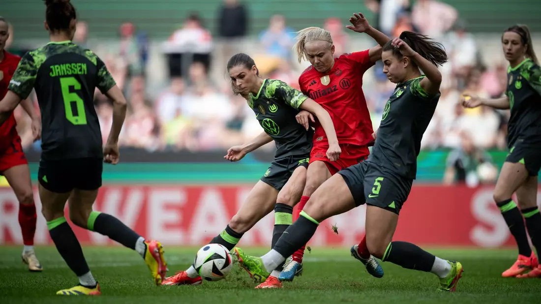 Wolfsburgs Jule Brand (l) und Lena Oberdorf kämpfen mit Bayerns Pernille Harder um den Ball. - Bild: Fabian Strauch/dpa