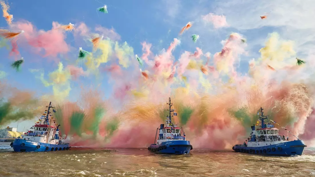Mit Schlepperballett und Farbbomben: Der Hamburger Hafen feiert Geburtstag. - Bild: Georg Wendt/dpa