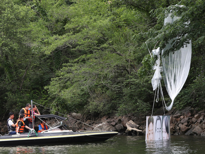 Südkoreanische Polizeibeamte sammeln einen hängengebliebenen Ballon ein (Archivbild). - Foto: Yang Ji-Woong/Yonhap/dpa