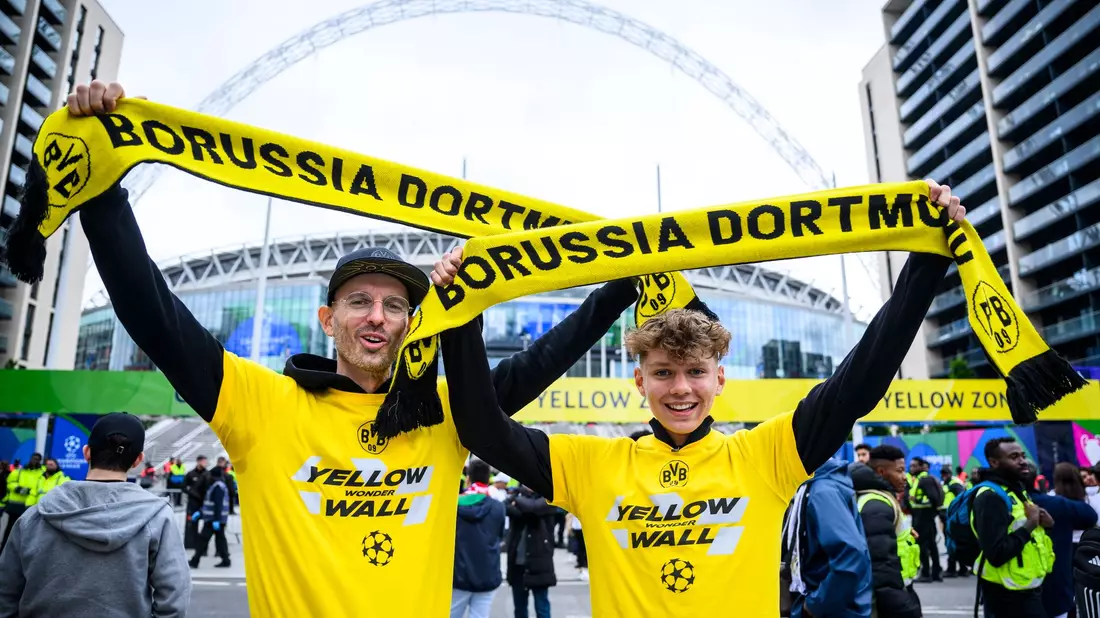 Zwei Fans von Borussia Dortmund stehen mit einem BVB-Fan-Schal vor dem Wembley-Stadion. - Bild: Tom Weller/dpa