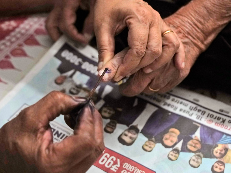 Wählerinnen und Wählern, die ihre Stimme abgegeben haben, wird der Finger mit Farbe markiert. Ergebnisse der Parlamentswahl in Indien soll es am 4. Juni geben. - Foto: Manish Swarup/AP/dpa