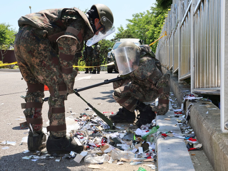 Südkoreanische Soldaten in Schutzkleidung untersuchen Müll aus einem aus Nordkorea entsandten Ballon. - Foto: Uncredited/YONHAP/AP/dpa