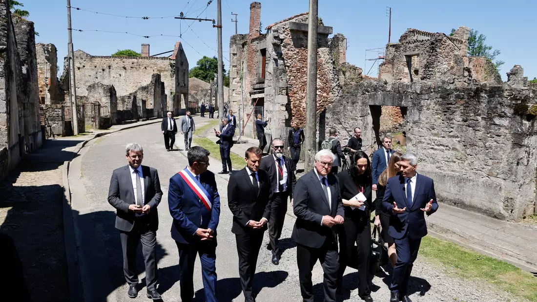 Der französische Präsident Emmanuel Macron und der deutsche Bundespräsident Frank-Walter Steinmeier gehen an Ruinen in Oradour-sur-Glane vorbei. - Bild: Ludovic Marin/AFP Pool/AP/dpa
