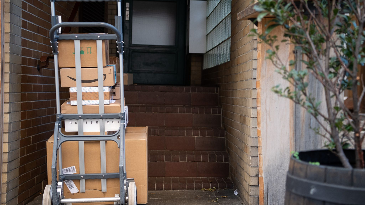 Gestapelte Pakete in einem Hauseingang. Das Postgesetz ist in seinen wesentlichen Teilen schon seit 1998 gültig. - Foto: Sebastian Gollnow/dpa