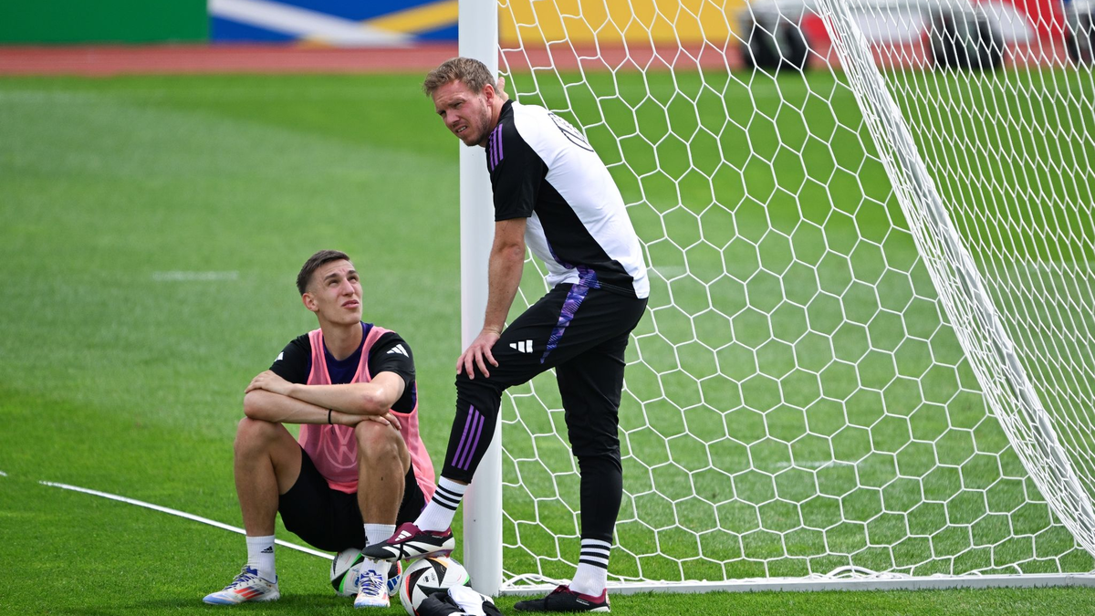 Bundestrainer Julian Nagelsmann im Gespräch mit Nico Schlotterbeck. - Foto: Federico Gambarini/dpa