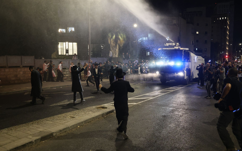 Die strengreligiösen Männer protestieren dagegen, dass auch sie zum Dienst an der Waffe verpflichtet werden. - Foto: Ilia Yefimovich/dpa Die strengreligiösen Männer protestieren dagegen, dass auch sie zum Dienst an der Waffe verpflichtet werden. - Foto: Ilia Yefimovich/dpa