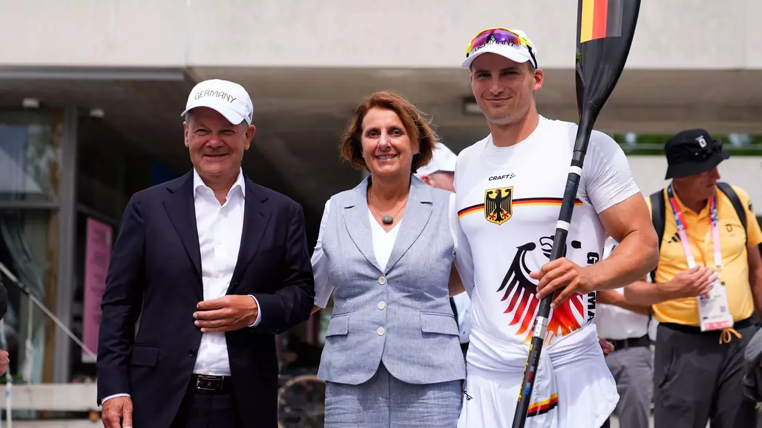 Kanu-Olympiasieger Tom Liebscher-Lucz (r) im Gespräch mit Bundeskanzler Olaf Scholz. - Bild: Lindsey Wasson/AP/dpa