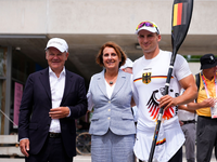 Kanu-Olympiasieger Tom Liebscher-Lucz (r) im Gespräch mit Bundeskanzler Olaf Scholz. - Foto: Lindsey Wasson/AP/dpa