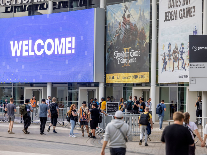 Besucher der Eröffnungsshow der Gamescom gehen zum Eingang der Kölner Messe. - Foto: Thomas Banneyer/dpa