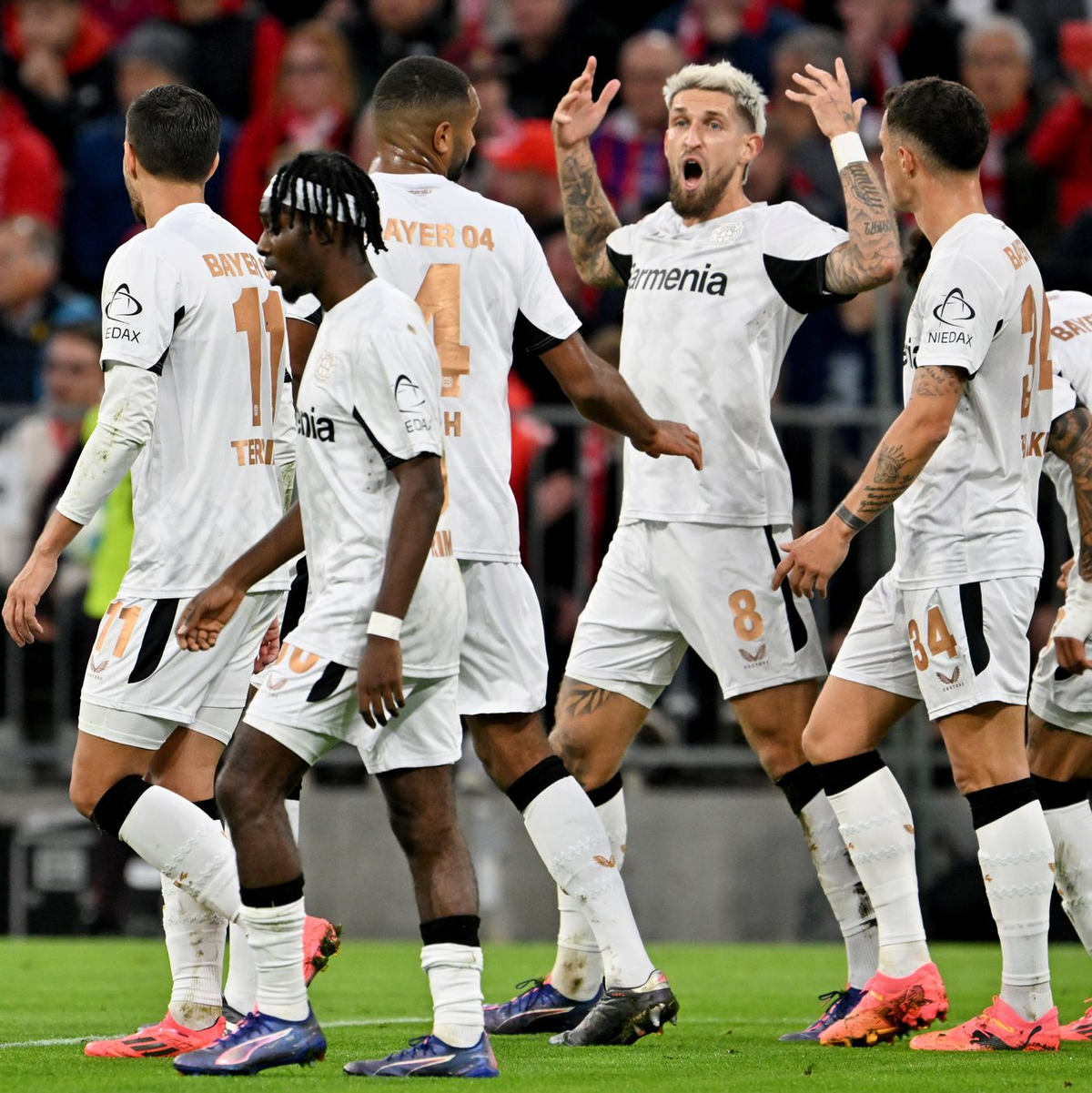 Die Spieler von Bayer Leverkusen bejubeln das 1:0 durch Robert Andrich (Mitte). - Foto: Peter Kneffel/dpa