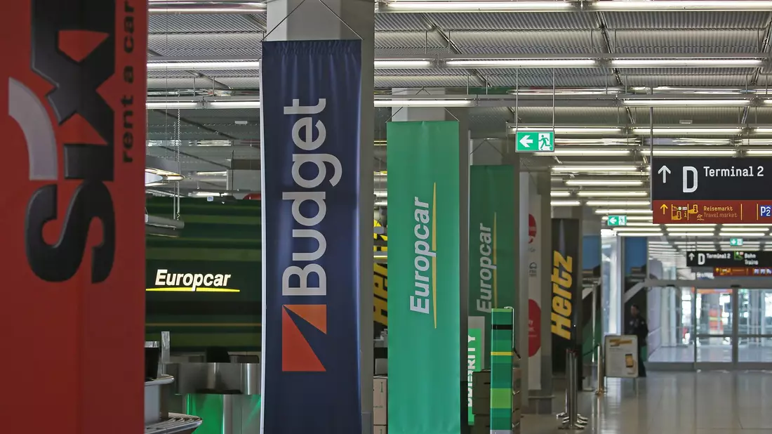 Mietwagenschalter am Flughafen. Die Preise sinken weiter, allerdings nicht mehr so schnell wie in den vergangenen Jahren.  - Bild: Oliver Berg/dpa
