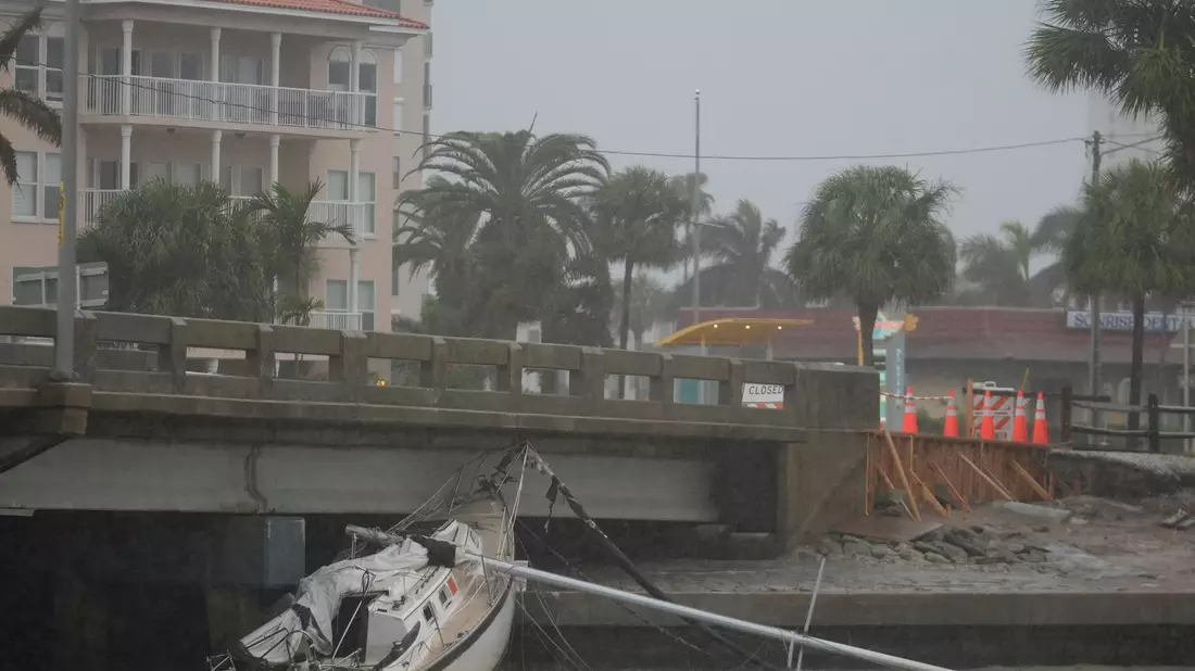 Ein von Hurrikan «Helene» beschädigtes Boot liegt unter einer Brücke, während sich «Milton» nähert. - Bild: Rebecca Blackwell/AP