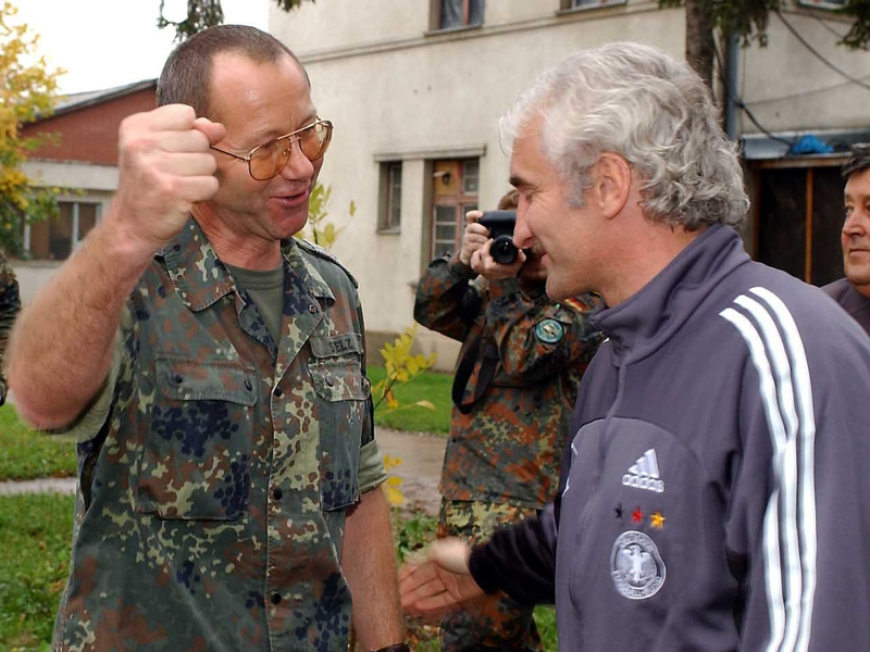 DFB-Teamchef Rudi Völler (r) wird beim Besuch bei den deutschen Soldaten der SFOR-Truppe im Feldlager Raijlovac in Sarajevo von Oberst Gerhard Stelz begrüßt. - Foto: Achim Scheidemann/dpa