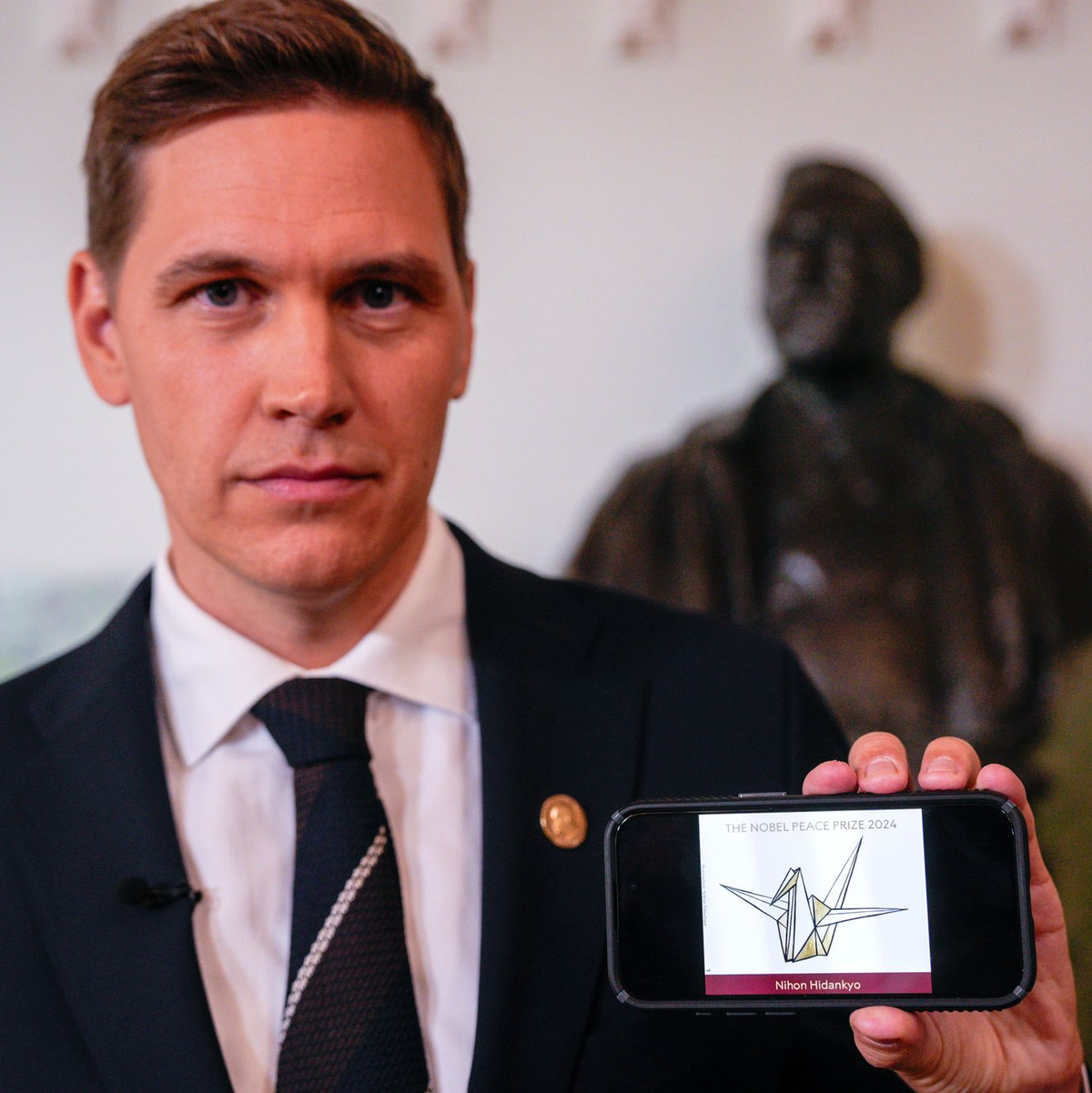 Der Vorsitzende des Nobelkomitees, Jørgen Watne Frydnes, zeigt das Logo der Gewinner-Organisation: eine stilisierte Friedenstaube.  - Foto: Javad Parsa/NTB/dpa