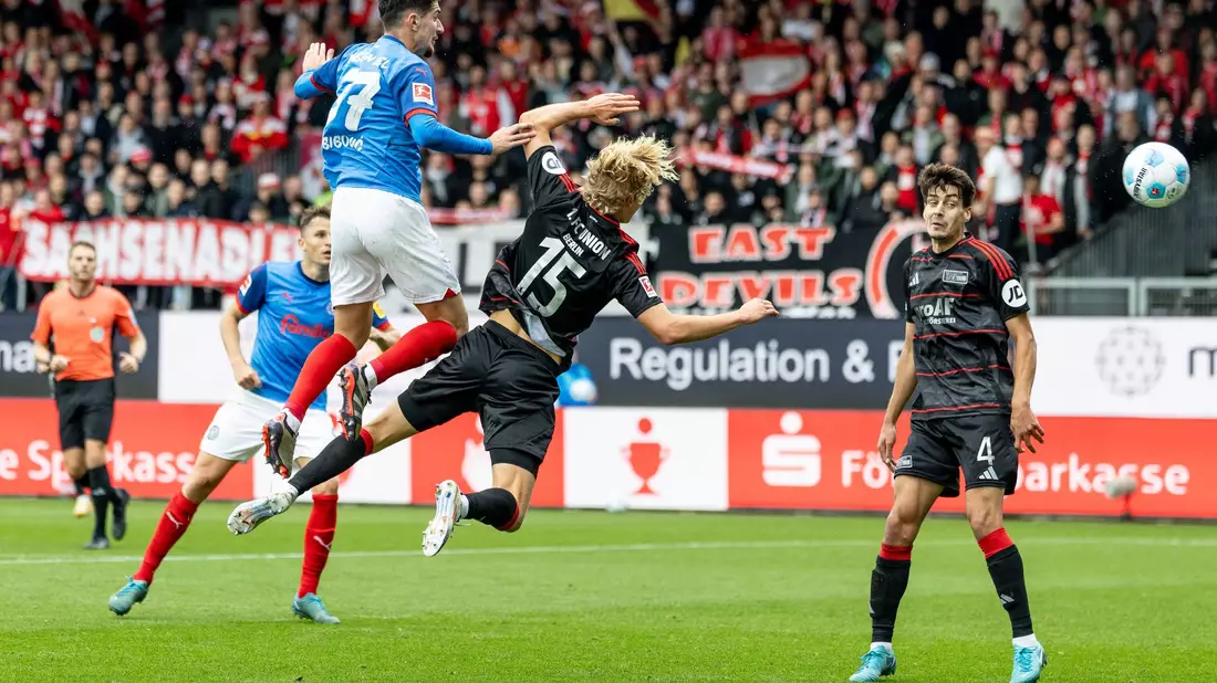 Berlins Aljoscha Kemlein (l) und Kiels Steven Skrzybski kämpfen um den Ball. - Bild: Axel Heimken/dpa