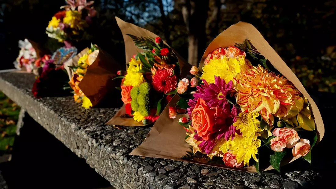 Blumensträuße in einem Park in Fall City. Die Menschen in der Stadt sind fassungslos.  - Bild: Jennifer Buchanan/The Seattle Times/AP