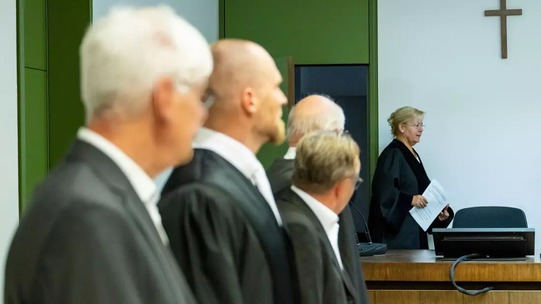 Die Angeklagten mit ihren Verteidigern zu Prozessbeginn. Im Hintergrund die Vorsitzende Richterin. (Archivbild) - Bild: Lennart Preiss/dpa