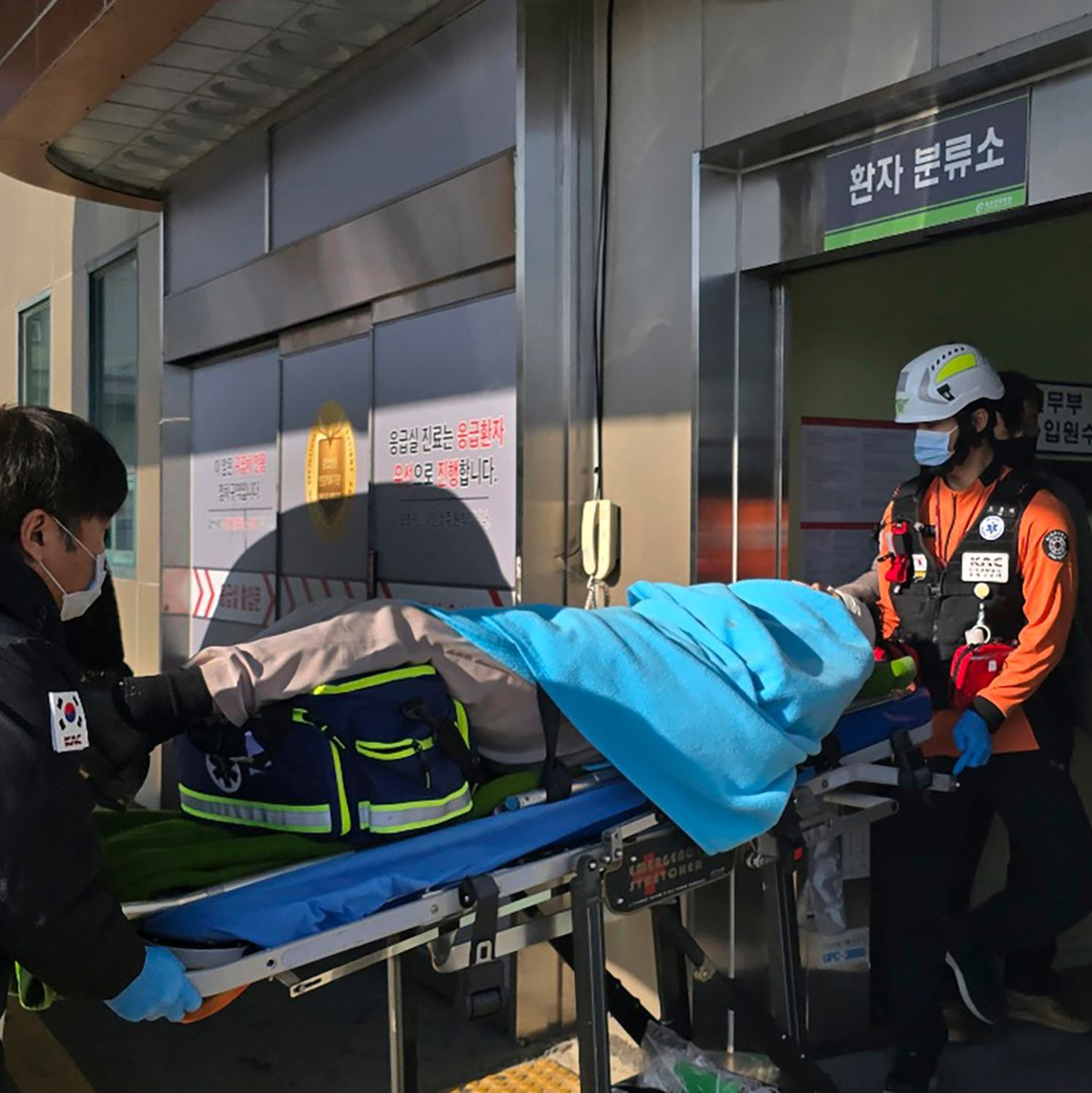 Ein nach einem Flugzeugabsturz gerettetes Opfer wird in ein Krankenhaus transportiert. - Foto: Cho Geun-young/Yonhap/AP/dpa