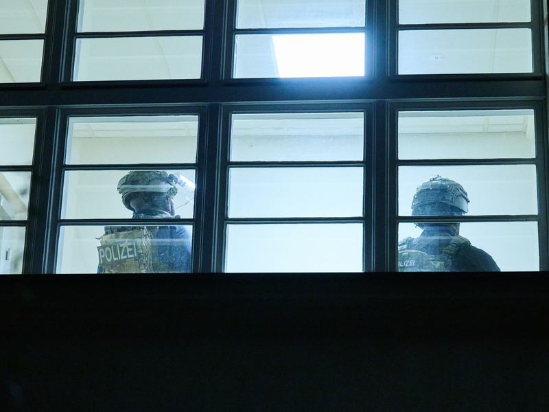 Schwerbewaffnete Polizisten durchsuchen eine Grundschule in Berlin. Doch am Abend kommt Entwarnung. - Foto: Annette Riedl/dpa