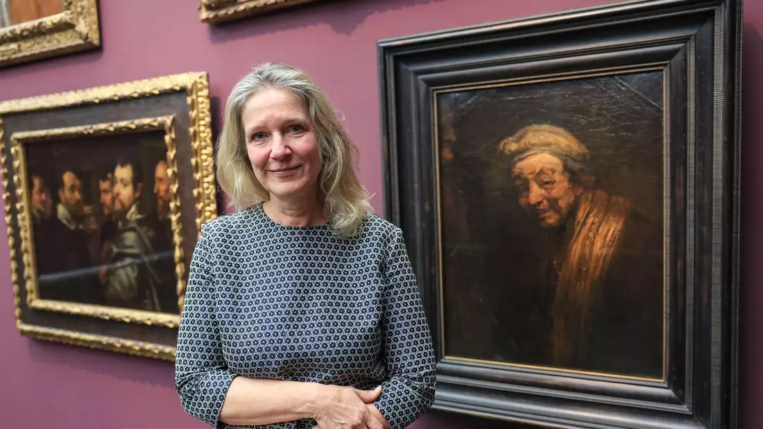Anja Sevcik steht zwischen einem Selbstbildnis von Peter Paul Rubens unter Freunden (links) und einem Selbstbildnis von Rembrandt (rechts).  - Bild: Oliver Berg/dpa